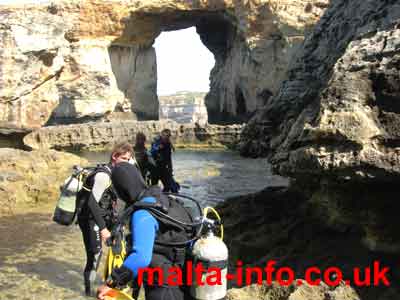 Photograph of divers walking towards the Blue hole. The Azure window in the background has now been totally destroyed by Gales